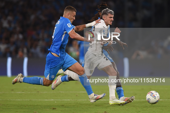 Valentin Mihaila of Parma Calcio competes for the ball with Alessandro Buongiorno of SSC Napoli during the Serie A match between SSC Napoli...