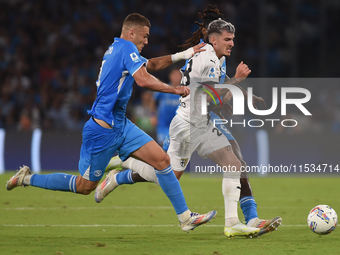 Valentin Mihaila of Parma Calcio competes for the ball with Alessandro Buongiorno of SSC Napoli during the Serie A match between SSC Napoli...