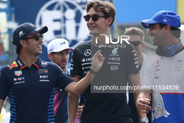 Sergio Perez of Red Bull Racing, George Russell of Mercedes and Daniel Ricciardo of RB before the Formula 1 Italian Grand Prix at Autodromo...