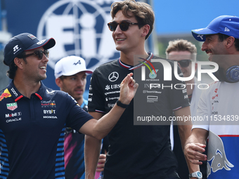 Sergio Perez of Red Bull Racing, George Russell of Mercedes and Daniel Ricciardo of RB before the Formula 1 Italian Grand Prix at Autodromo...