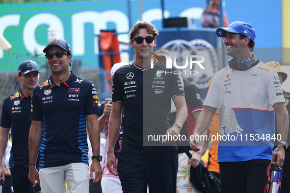 Sergio Perez of Red Bull Racing, George Russell of Mercedes and Daniel Ricciardo of RB before the Formula 1 Italian Grand Prix at Autodromo...