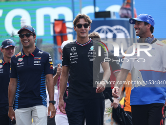 Sergio Perez of Red Bull Racing, George Russell of Mercedes and Daniel Ricciardo of RB before the Formula 1 Italian Grand Prix at Autodromo...