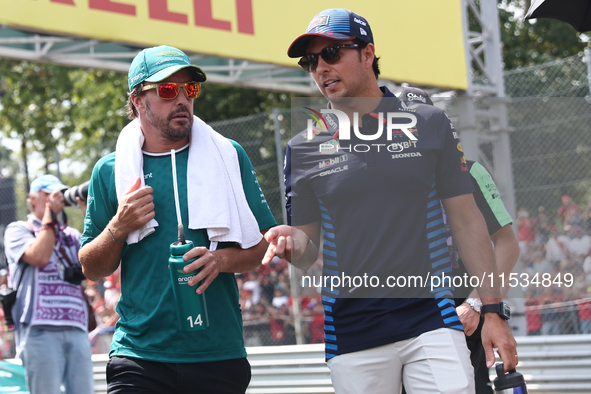 Fernando Alonso of Aston Martin Aramco and Sergio Perez of Red Bull Racing before the Formula 1 Italian Grand Prix at Autodromo Nazionale di...