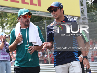 Fernando Alonso of Aston Martin Aramco and Sergio Perez of Red Bull Racing before the Formula 1 Italian Grand Prix at Autodromo Nazionale di...