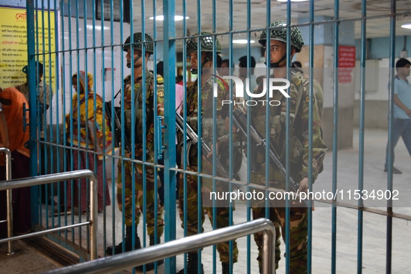 Bangladesh army personnel stand guard at Dhaka Medical College Hospital as medical services in the emergency department remain suspended in...