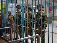 Bangladesh army personnel stand guard at Dhaka Medical College Hospital as medical services in the emergency department remain suspended in...