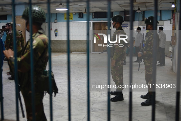 Bangladesh army personnel stand guard at Dhaka Medical College Hospital as medical services in the emergency department remain suspended in...