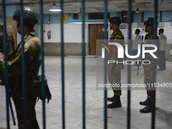 Bangladesh army personnel stand guard at Dhaka Medical College Hospital as medical services in the emergency department remain suspended in...