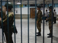 Bangladesh army personnel stand guard at Dhaka Medical College Hospital as medical services in the emergency department remain suspended in...