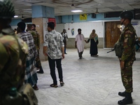 Bangladesh army personnel stand guard at Dhaka Medical College Hospital as medical services in the emergency department remain suspended in...