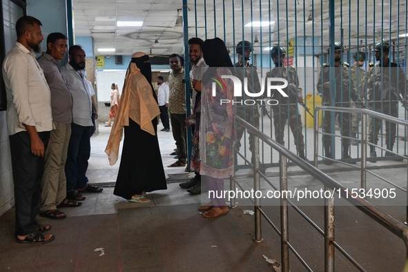 Bangladesh army personnel stand guard at Dhaka Medical College Hospital as medical services in the emergency department remain suspended in...