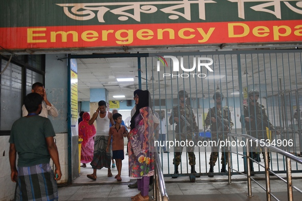 Bangladesh army personnel stand guard at Dhaka Medical College Hospital as medical services in the emergency department remain suspended in...