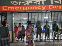 Bangladesh army personnel stand guard at Dhaka Medical College Hospital as medical services in the emergency department remain suspended in...