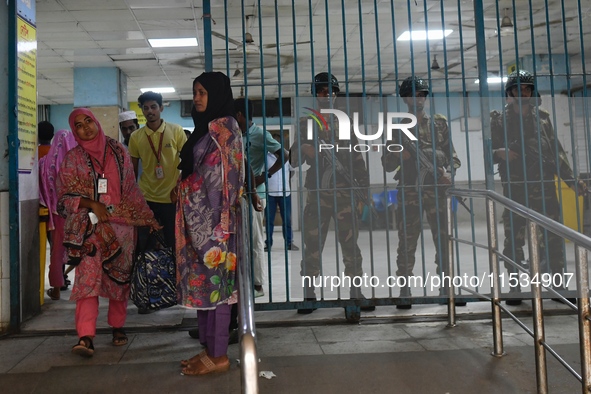 Bangladesh army personnel stand guard at Dhaka Medical College Hospital as medical services in the emergency department remain suspended in...