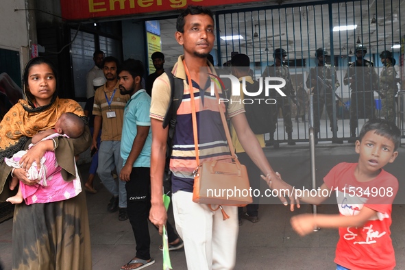 Bangladesh army personnel stand guard at Dhaka Medical College Hospital as medical services in the emergency department remain suspended in...