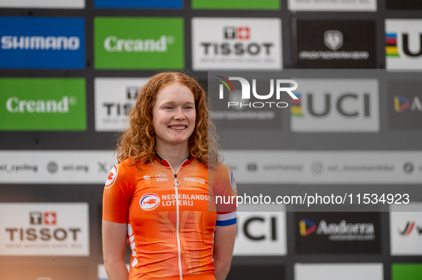 Puck Pieterse of the Netherlands stands on the podium at the UCI Mountain Bike World Championships Women in Pal Arinsal, Andorra, on Septemb...