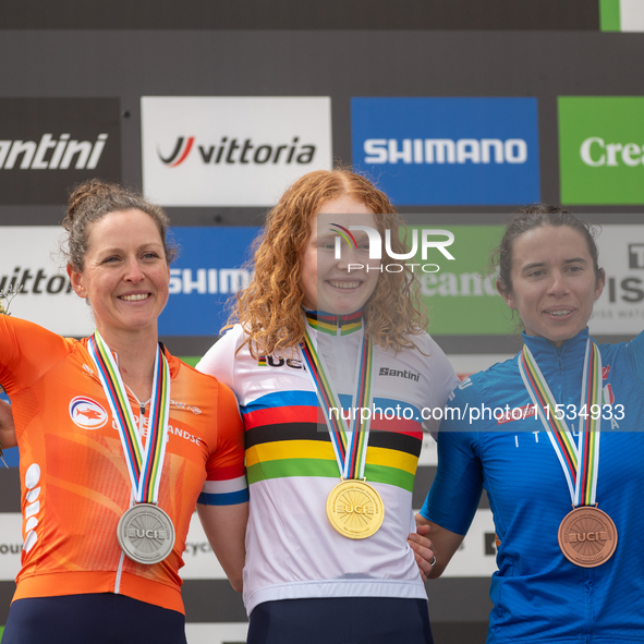 Anne Terpstra of the Netherlands, Martina Berta of Italy, and Puck Pieterse of the Netherlands stand on the podium at the UCI Mountain Bike...