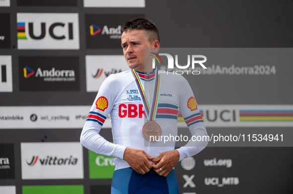 Thomas Pidcock of Great Britain stands on the podium at the UCI Mountain Bike World Championships Men Under 23 Race in Pal Arinsal, Andorra,...