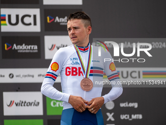 Thomas Pidcock of Great Britain stands on the podium at the UCI Mountain Bike World Championships Men Under 23 Race in Pal Arinsal, Andorra,...