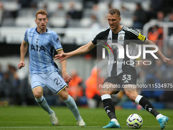 Newcastle United's Dan Burn makes a clearance during the Premier League match between Newcastle United and Tottenham Hotspur at St. James's...