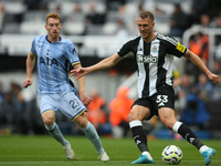 Newcastle United's Dan Burn makes a clearance during the Premier League match between Newcastle United and Tottenham Hotspur at St. James's...