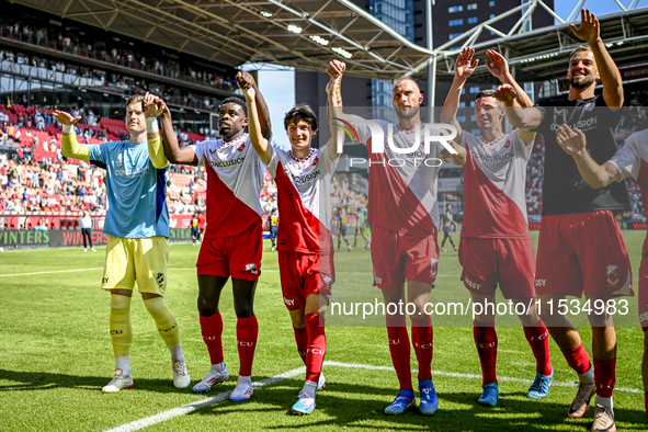 FC Utrecht players Noah Ohio, Paxten Aaronson, Mike van der Hoorn, and Nick Viergever celebrate the win during the match between Utrecht and...