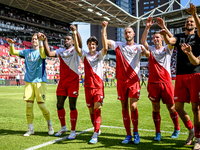 FC Utrecht players Noah Ohio, Paxten Aaronson, Mike van der Hoorn, and Nick Viergever celebrate the win during the match between Utrecht and...