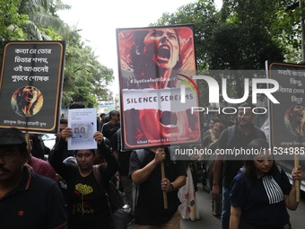 Ramakrishna Mission alumni and office staff take part in a protest march against a doctor's rape and murder in Kolkata, India, on September...