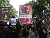 Ramakrishna Mission alumni and office staff take part in a protest march against a doctor's rape and murder in Kolkata, India, on September...