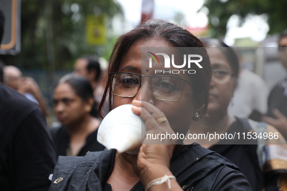 Ramakrishna Mission alumni and office staff take part in a protest march against a doctor's rape and murder in Kolkata, India, on September...