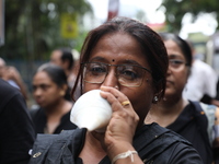 Ramakrishna Mission alumni and office staff take part in a protest march against a doctor's rape and murder in Kolkata, India, on September...