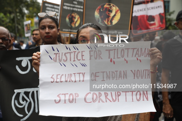 Ramakrishna Mission alumni and office staff take part in a protest march against a doctor's rape and murder in Kolkata, India, on September...