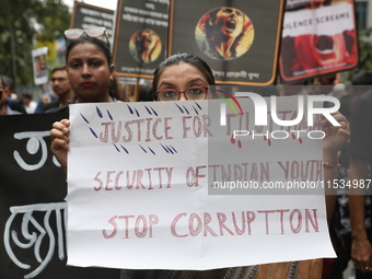 Ramakrishna Mission alumni and office staff take part in a protest march against a doctor's rape and murder in Kolkata, India, on September...