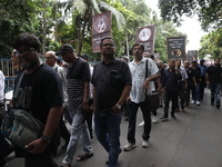 Ramakrishna Mission alumni and office staff take part in a protest march against a doctor's rape and murder in Kolkata, India, on September...