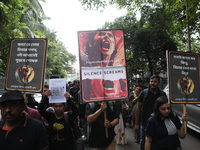 Ramakrishna Mission alumni and office staff take part in a protest march against a doctor's rape and murder in Kolkata, India, on September...