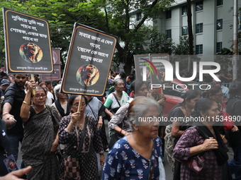 Ramakrishna Mission alumni and office staff take part in a protest march against a doctor's rape and murder in Kolkata, India, on September...