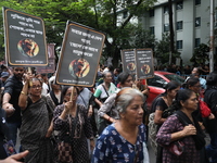 Ramakrishna Mission alumni and office staff take part in a protest march against a doctor's rape and murder in Kolkata, India, on September...