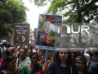 Ramakrishna Mission alumni and office staff take part in a protest march against a doctor's rape and murder in Kolkata, India, on September...