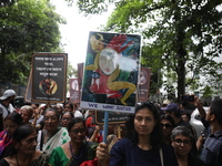 Ramakrishna Mission alumni and office staff take part in a protest march against a doctor's rape and murder in Kolkata, India, on September...