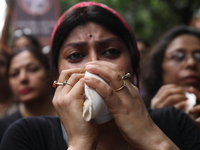 Ramakrishna Mission alumni and office staff take part in a protest march against a doctor's rape and murder in Kolkata, India, on September...