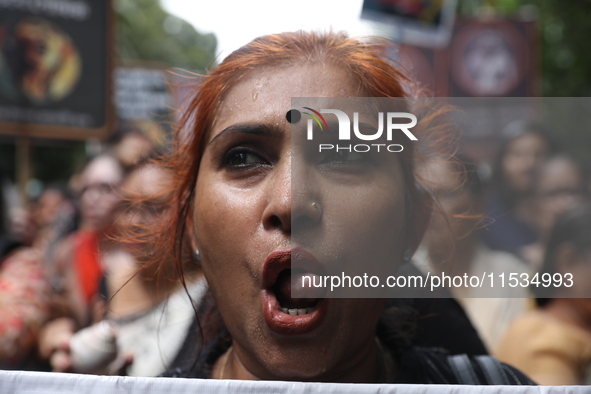 Ramakrishna Mission alumni and office staff take part in a protest march against a doctor's rape and murder in Kolkata, India, on September...