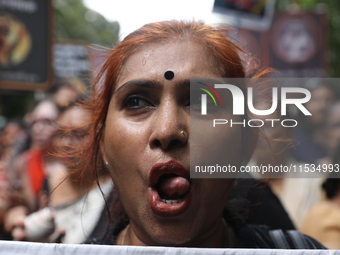 Ramakrishna Mission alumni and office staff take part in a protest march against a doctor's rape and murder in Kolkata, India, on September...