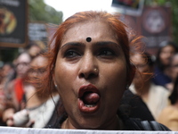 Ramakrishna Mission alumni and office staff take part in a protest march against a doctor's rape and murder in Kolkata, India, on September...