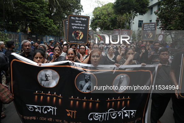 Ramakrishna Mission alumni and office staff take part in a protest march against a doctor's rape and murder in Kolkata, India, on September...