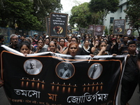 Ramakrishna Mission alumni and office staff take part in a protest march against a doctor's rape and murder in Kolkata, India, on September...