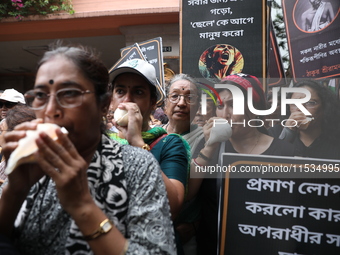 Ramakrishna Mission alumni and office staff take part in a protest march against a doctor's rape and murder in Kolkata, India, on September...