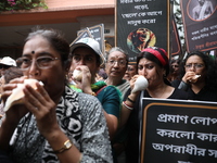 Ramakrishna Mission alumni and office staff take part in a protest march against a doctor's rape and murder in Kolkata, India, on September...