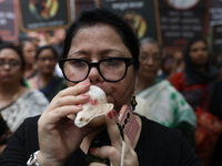 Ramakrishna Mission alumni and office staff take part in a protest march against a doctor's rape and murder in Kolkata, India, on September...