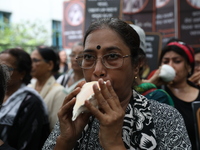 Ramakrishna Mission alumni and office staff take part in a protest march against a doctor's rape and murder in Kolkata, India, on September...