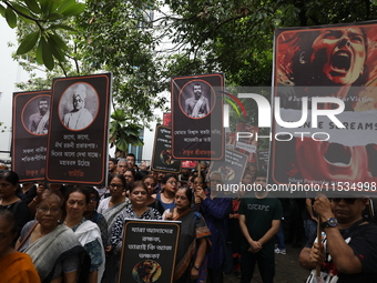 Ramakrishna Mission alumni and office staff take part in a protest march against a doctor's rape and murder in Kolkata, India, on September...